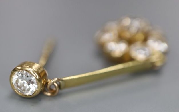 A single yellow metal and diamond cluster set drop earring, 32mm, cluster 10mm, gross 1.7 grams.